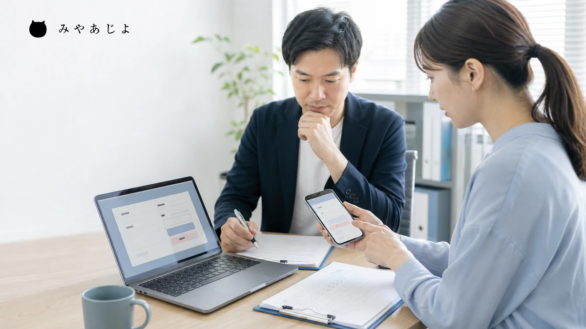 担当者がスマートフォンとパソコンで問い合わせフォームを検証するイメージ